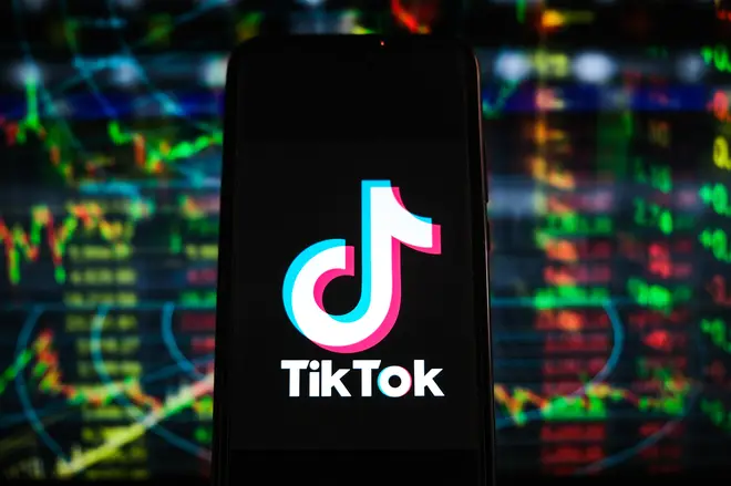 In this photo illustration a TikTok logo is displayed on a...