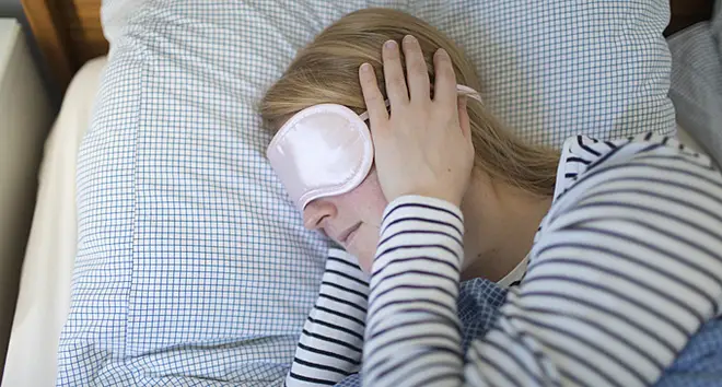 Woman in an eye mask sleeping