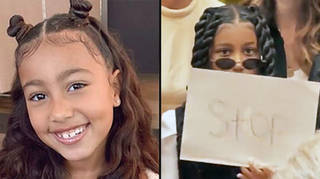 North West waves "STOP" sign at paparazzi constantly taking her photo