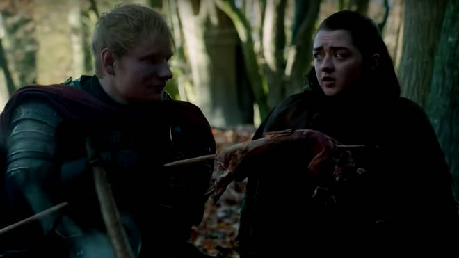 Arya tucks into what looks like a rodent, as Ed awkwardly avoids looking at the camera