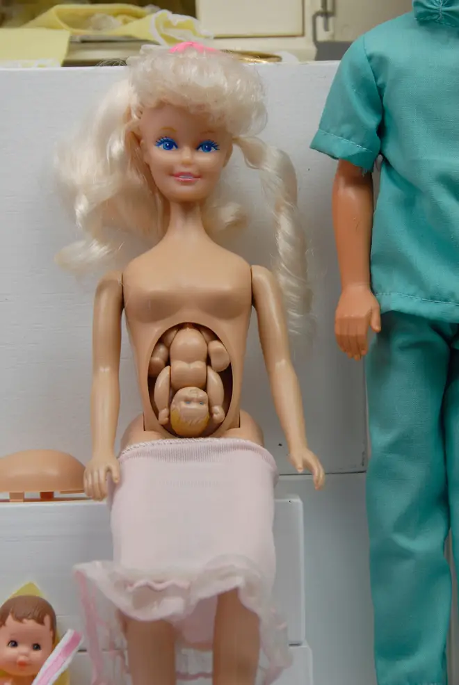 Pregnant Midge Barbie with a detachable bump containing an articulated foetus amid Barbie set doll exhibit at the Toy museum in Prague Czech Republic